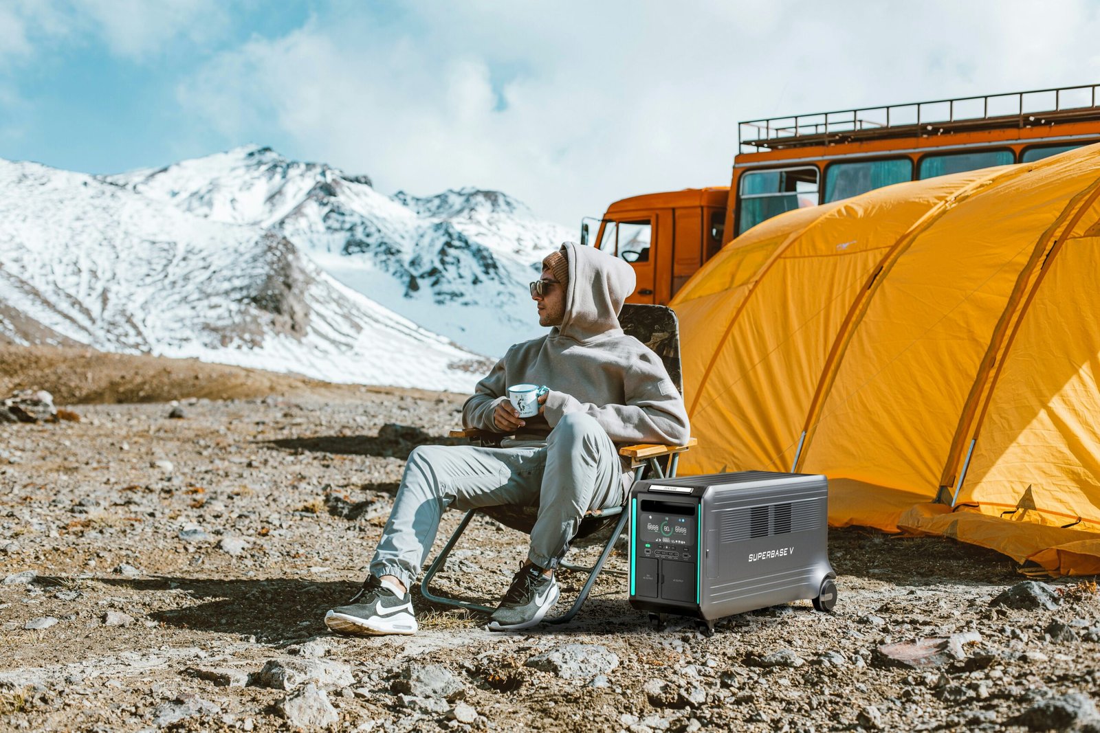 Portable power station beside a tent at a mountain campsite