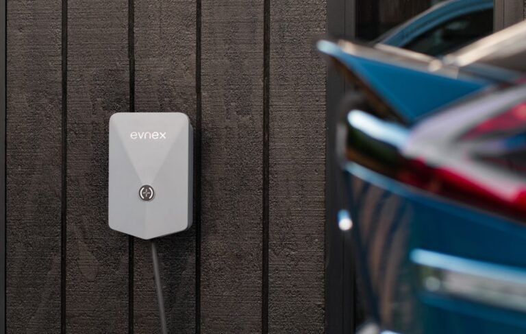 Electric car connected to a wall-mounted home charging unit