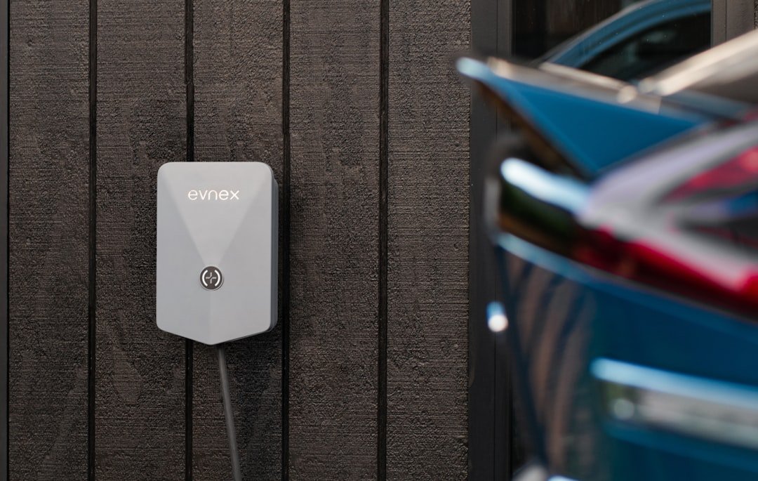 Electric car connected to a wall-mounted home charging unit