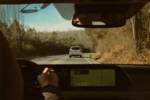 Driver view of a road trip dashboard and open road ahead
