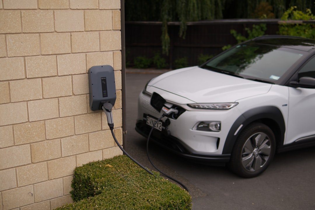 Electric car plugged into a home charging station outdoors