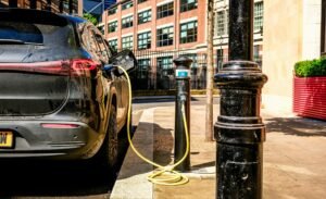 Electric vehicle charging on a city street, used as a visual for EV shopping research