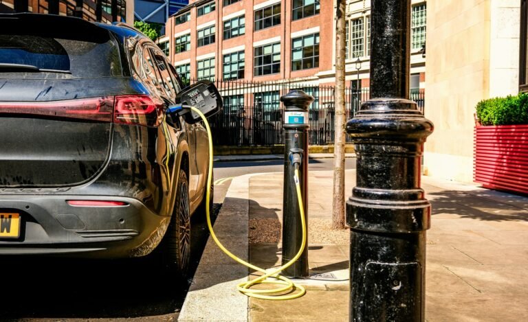 Electric vehicle charging on a city street, used as a visual for EV shopping research