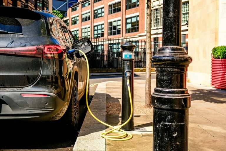Electric vehicle charging on a city street, used as a visual for EV shopping research