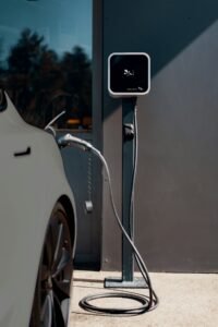 Electric vehicle wheel and charging cable at a public charging station