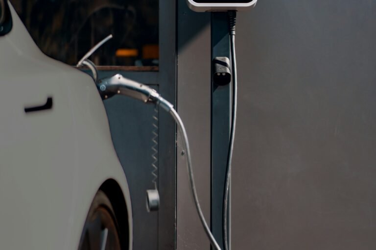 Electric vehicle wheel and charging cable at a public charging station