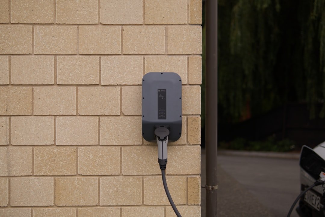 Close-up of a home charging plug connected to a wall outlet