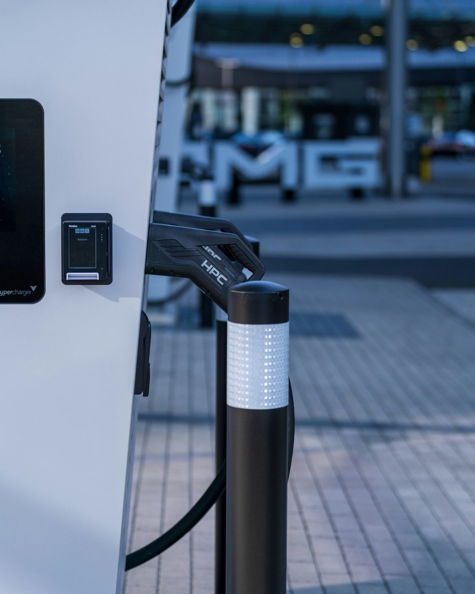 High-power electric vehicle charging connector docked at a public charging station