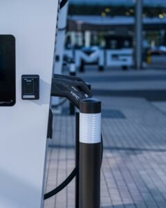 High-power electric vehicle charging connector docked at a public charging station