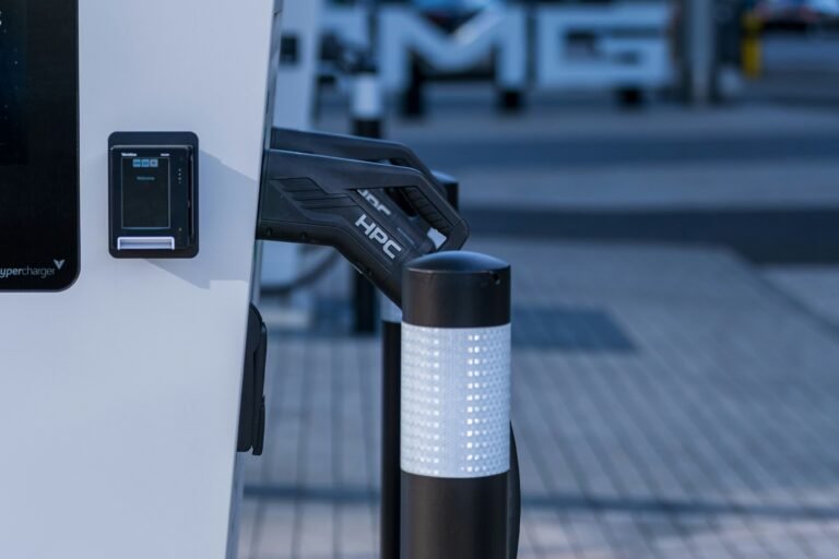 High-power electric vehicle charging connector docked at a public charging station